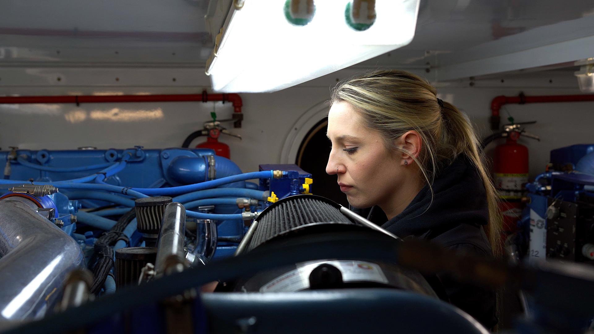 Marine Technician inspecting an engine at Maple Leaf Marinas facility
